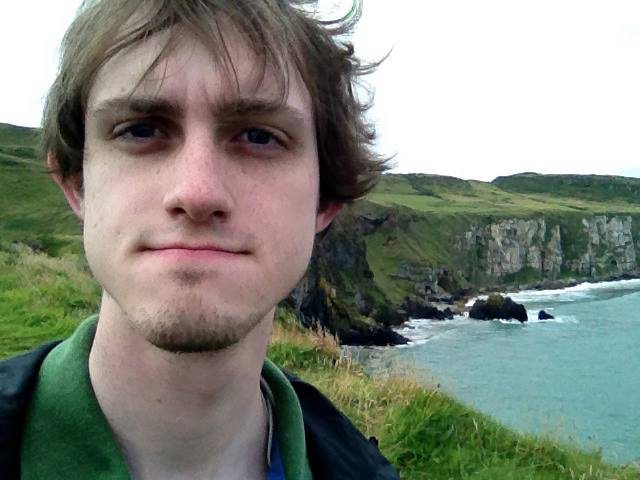 A picture of Philip Peterson set atop the beautiful green cliffs of Ireland